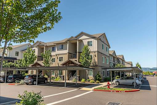 A row of houses with a car parked in front of them at Forestplace Apartment Homes, Forest Grove, OR, 97116