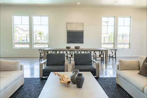 A living room with a white couch, a white coffee table, and a large painting on the wall at Northplace Apartment Homes, Oregon, 97305