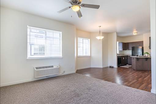 A room with a ceiling fan and a window with blinds at Riverplace Apartment Homes, Independence, OR, 97351