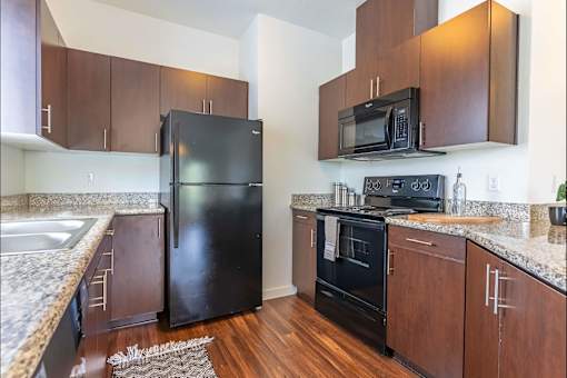 A kitchen with a black refrigerator and black oven at Riverplace Apartment Homes, Independence, OR