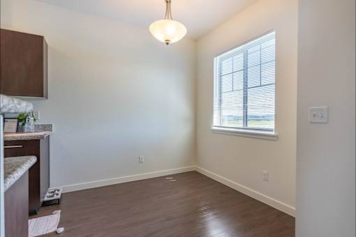 A room with a window and a hanging light fixture at Riverplace Apartment Homes, Oregon
