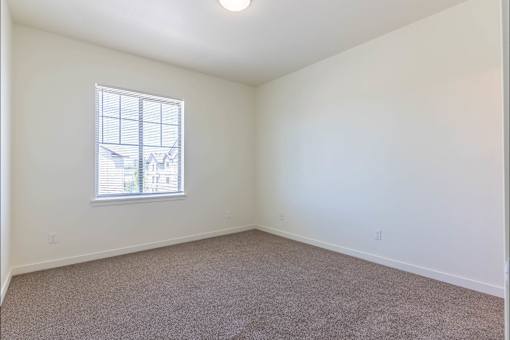 A room with a carpeted floor and a window at Riverplace Apartment Homes, Oregon, 97351