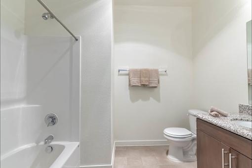 A white bathroom with a toilet, sink, and bathtub at Riverplace Apartment Homes, Oregon