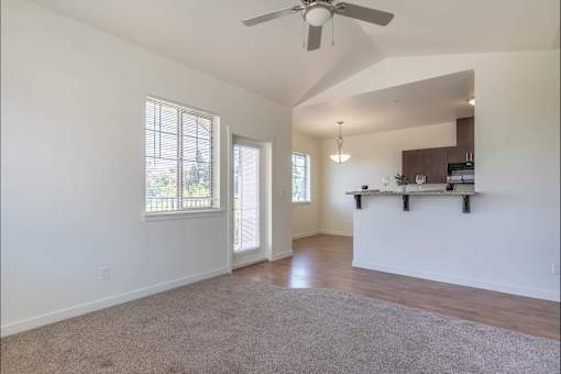 A spacious room with a ceiling fan and a window at Riverplace Apartment Homes, Oregon, 97351