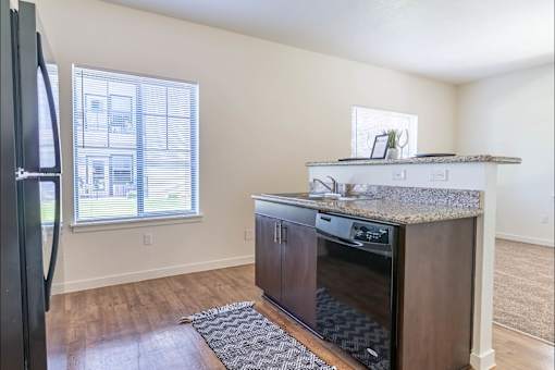 A kitchen with a refrigerator, oven, and microwave at Riverplace Apartment Homes, Independence, Oregon