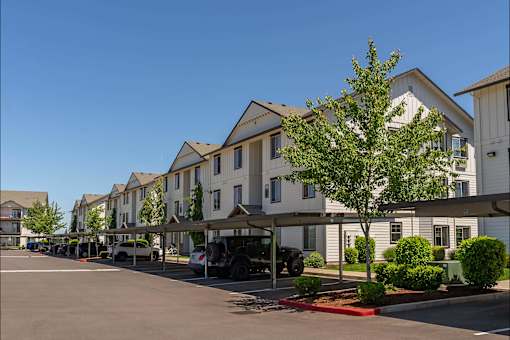 A row of houses with a tree in front of them at Riverplace Apartment Homes, Oregon, 97351