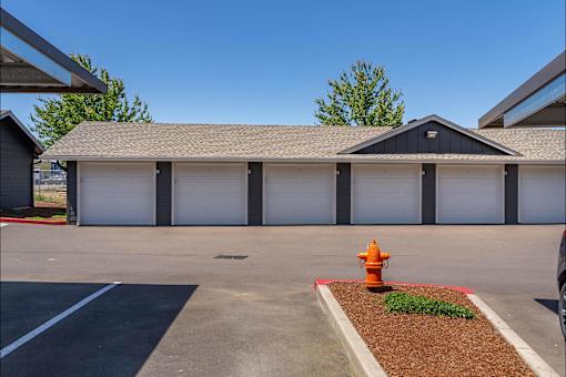 A fire hydrant is in front of a garage at Riverplace Apartment Homes, Independence, OR, 97351