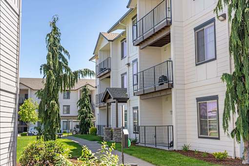 A sunny day at a residential apartment complex with a clear blue sky at Riverplace Apartment Homes, Independence, 97351