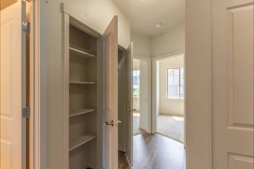 A white pantry with an open door leading to a hallway at Sandyplace Apartment Homes, Sandy, 97055