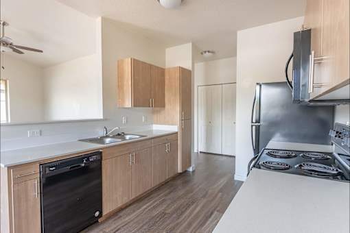 A kitchen with a black dishwasher and stove top oven at Silverplace Apartment Homes, Silverton, 97381