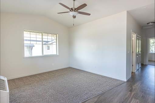 A room with a ceiling fan and a window at Silverplace Apartment Homes, Oregon