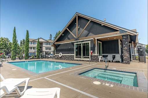 A house with a pool in front of it at Silverplace Apartment Homes, Oregon