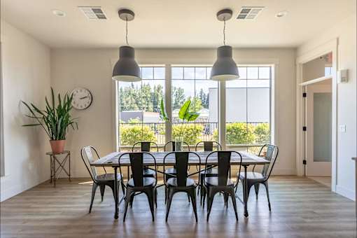 A dining room with a table set for six at Silverplace Apartment Homes, Silverton