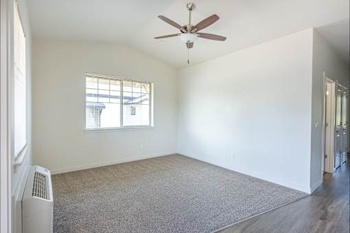 A room with a ceiling fan and a window at Silverplace Apartment Homes, Silverton, OR