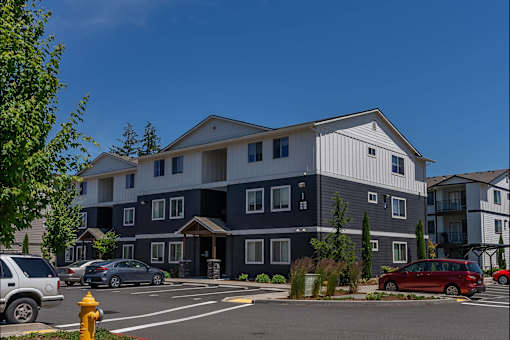 A building with a parking lot in front of it at St Helens Place Apartment Homes, St Helens