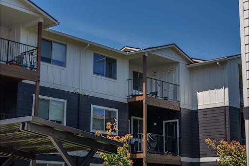 Apartment building with balconies and flower pots at St Helens Place Apartment Homes, Oregon