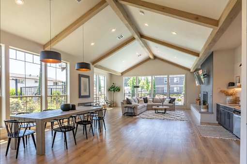 A spacious living room with a high ceiling and wooden floors at St Helens Place Apartment Homes, St Helens, OR
