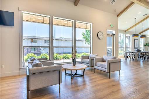 A living room with a grey sofa and a wooden floor at St Helens Place Apartment Homes, St Helens, Oregon