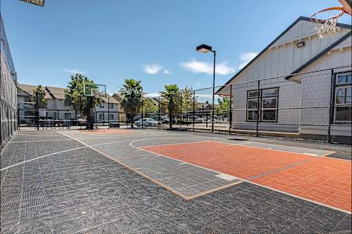 A basketball court with a basketball hoop and a basketball net at Stoneplace Apartment Homes, Molalla