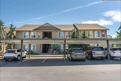 A building with a parking lot in front of it at Stoneplace Apartment Homes, Molalla, Oregon