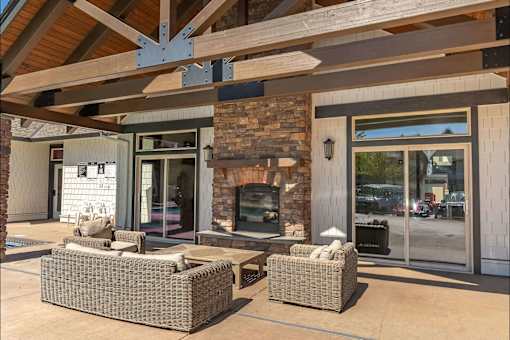 A patio with a fireplace and seating area at Stoneplace Apartment Homes, Molalla, OR