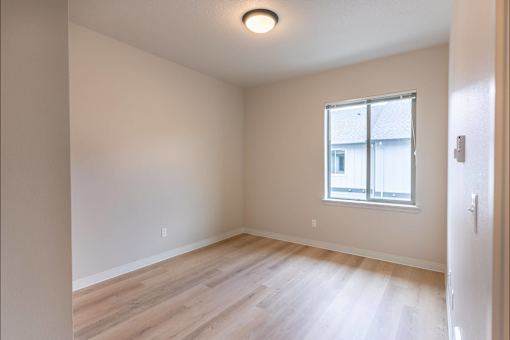 A room with a window and wooden flooring at Woodburn Place Apartment Homes, Oregon, 97071