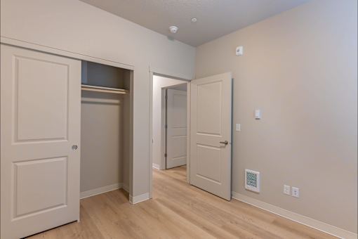 A room with three doors and a light switch on the wall at Woodburn Place Apartment Homes, Woodburn