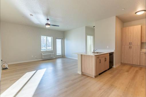 A room with wooden floors and a ceiling fan at Woodburn Place Apartment Homes, Woodburn, OR, 97071
