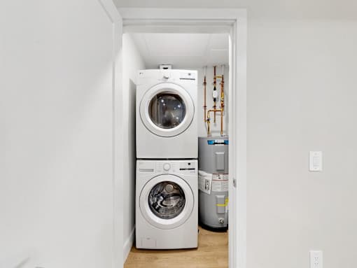 A white washing machine and dryer in a small laundry room.