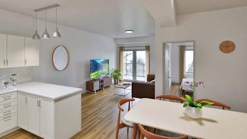 A modern kitchen with white cabinets and a wooden table.