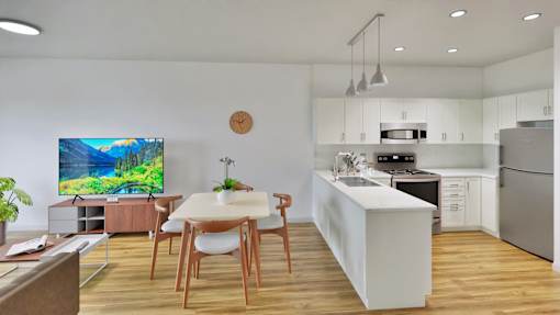 A modern kitchen with a dining table and chairs.