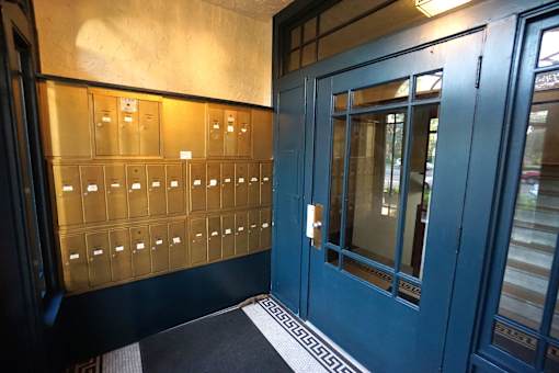 A blue door with a glass window and a metal handle.