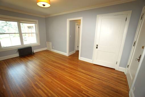 A room with wooden floors and white doors.
