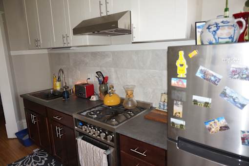 Updated kitchen with stainless steel appliances custom cabinetry and marble backsplash.