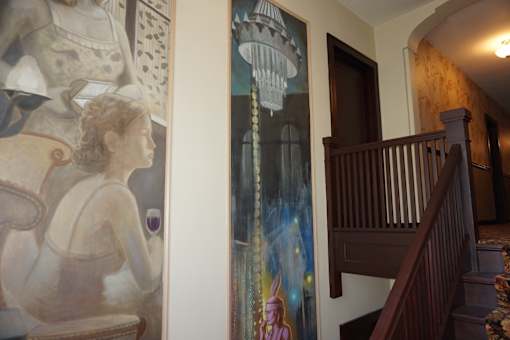 A painting of a woman is on the wall.