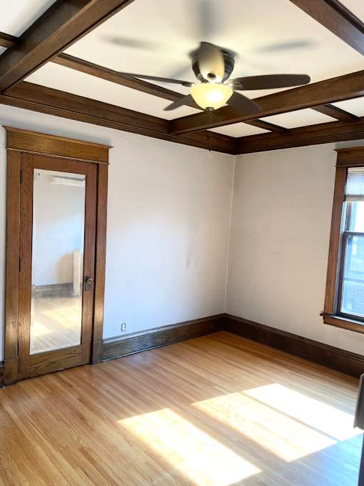 Large bedroom with coffered oak ceiling.