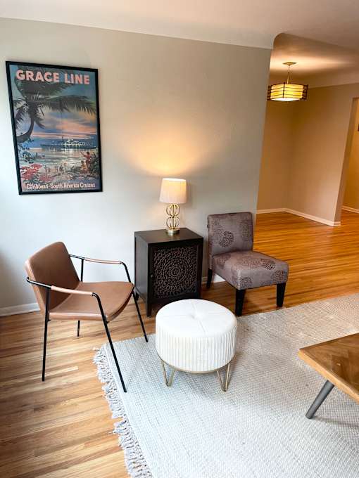 A living room with a Grace Line poster on the wall.
