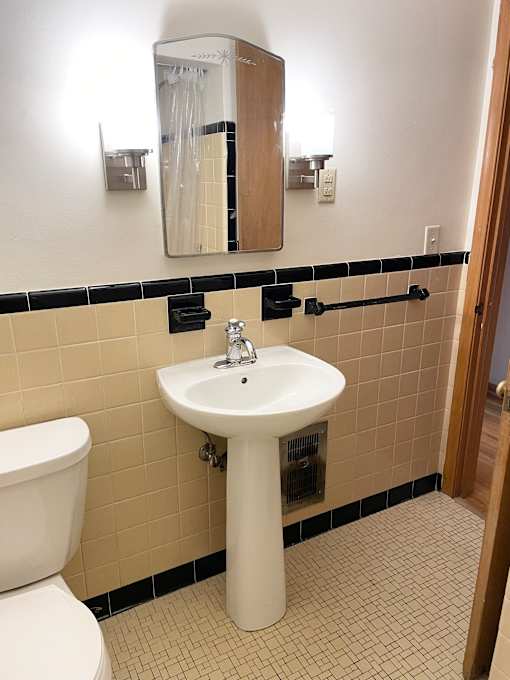 Classic vintage deco-tiled bathroom.
