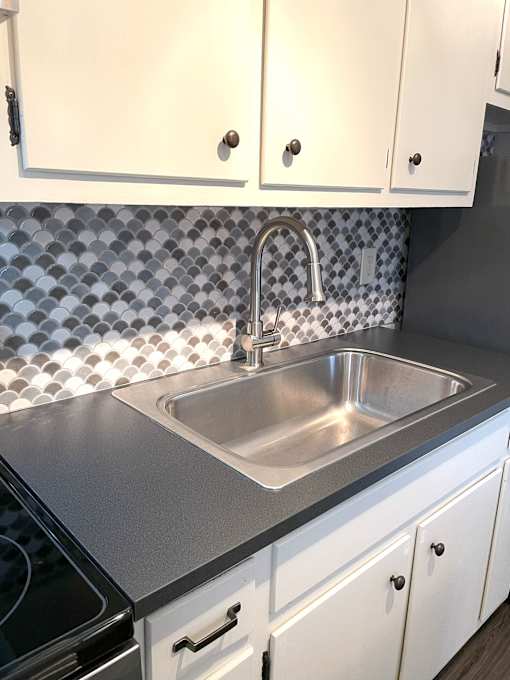 A kitchen with a sink and cabinets.