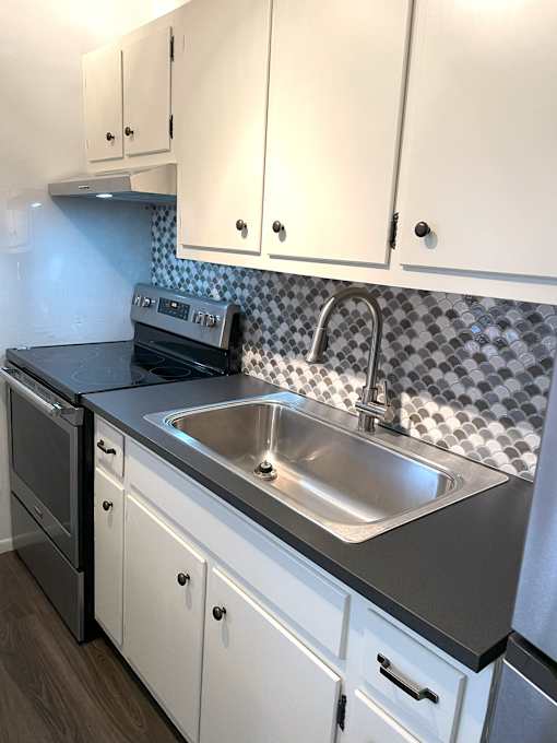 A kitchen with a sink and a stove.