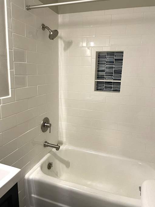 Tastefully renovated bathroom with full ceramic tiled shower, walls and floor.