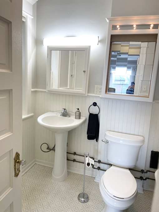 A white sink and toilet in a bathroom.