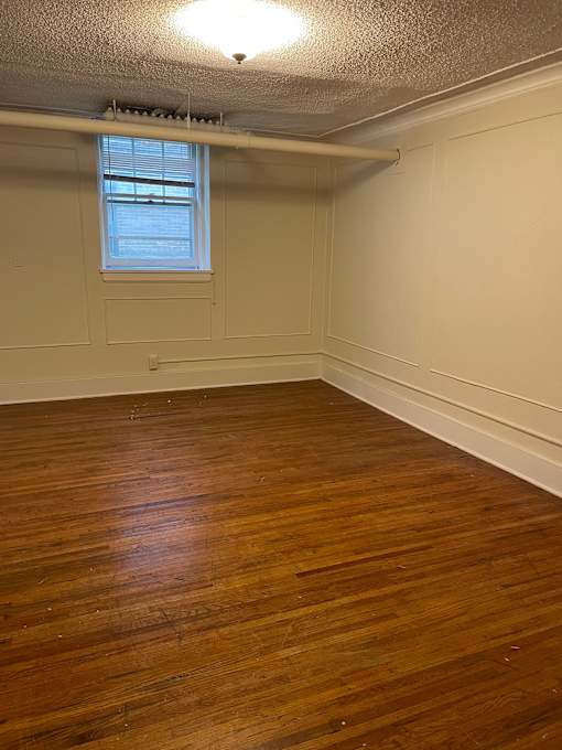 A room with wooden floors and a window.