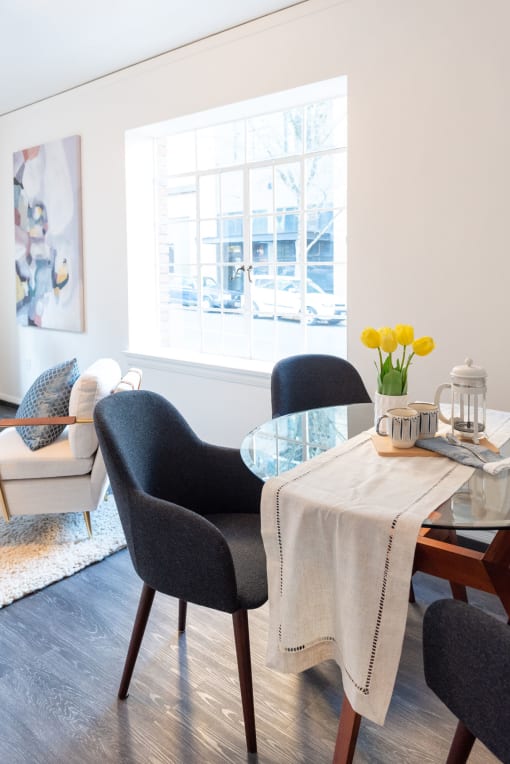 dining nook with living room and large picture window behind