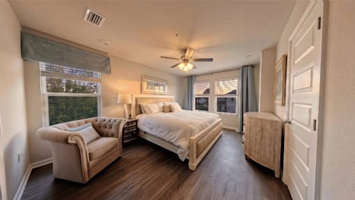 A bedroom with a large bed and a couch.