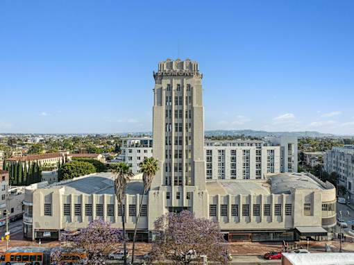 A large building with a tall tower and a lot of windows.