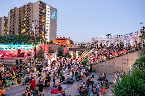 A large crowd of people are gathered in an outdoor amphitheater.