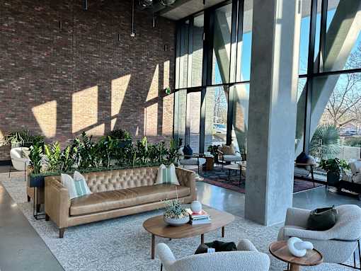 A living room with a couch, chairs, and a coffee table.