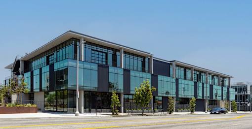 A modern building with large glass windows and a black and white exterior.