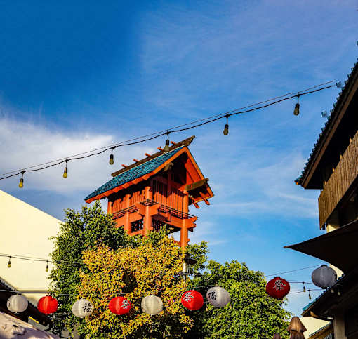A traditional Japanese building with a red lantern hanging in front of it.
